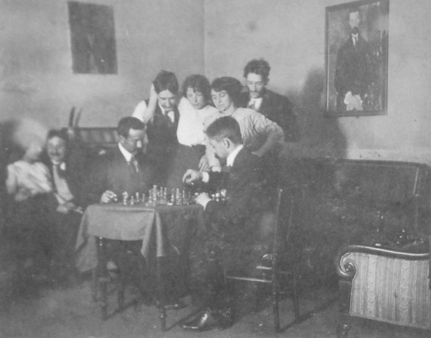 playing chess inside the delta studios in 1912- the beggar can be seen on the left wall